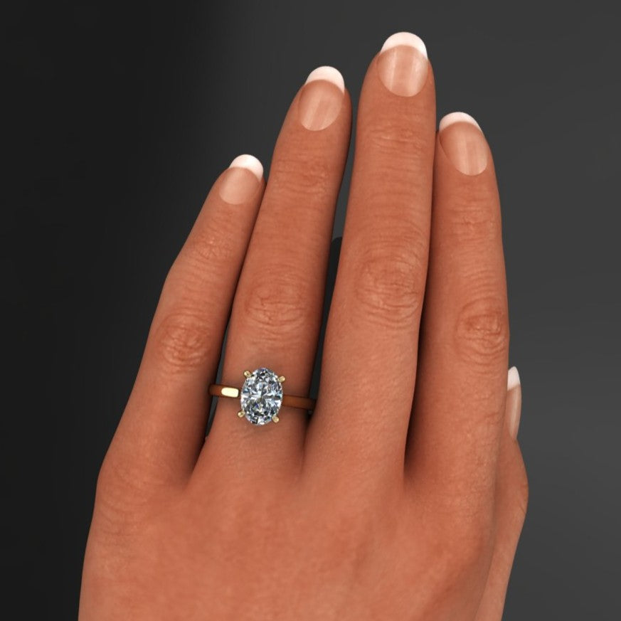 2.5 carat oval moissanite ring in a cathedral setting with a diamond side halo - hand model 