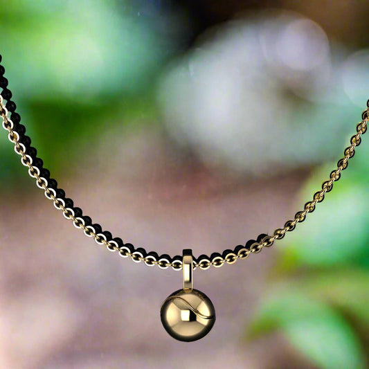 Petite gold tennis ball necklace - front view